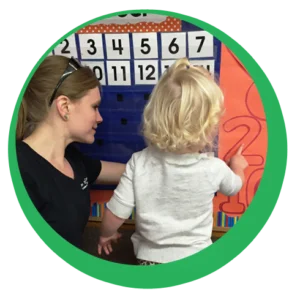 Teacher and child learning numbers and calendar at school teacher
